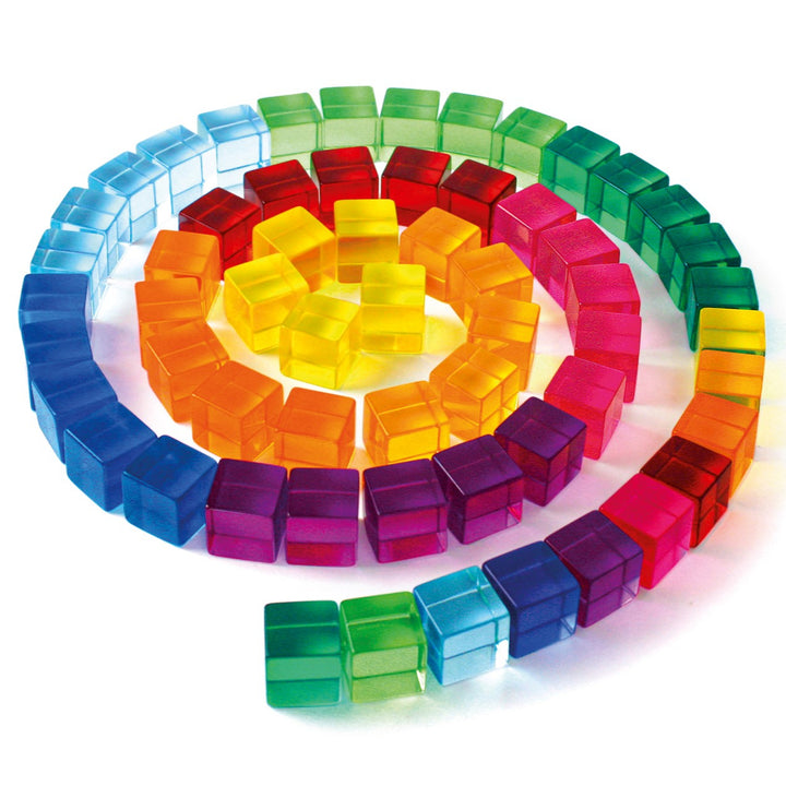 Colourful transparent building blocks arranged in a circular pattern on a white background